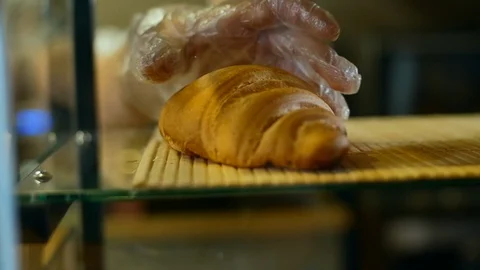 Close up shot of taking out the fresh baked croissant from the shelf Stock-Footage 108555849