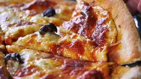 Close up shot of taking a piece of freshly baked pizza with tasty stretchy Stock-Footage 336586734