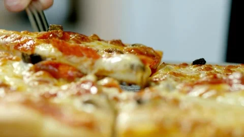 Close up shot of taking a piece of freshly baked pizza with tasty stretchy Video stock 336586780