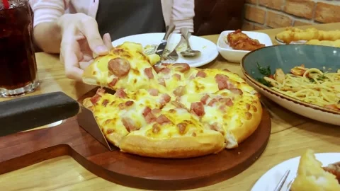 Close up shot of taking a piece of freshly baked pizza with tasty stretchy Video stock 336586781