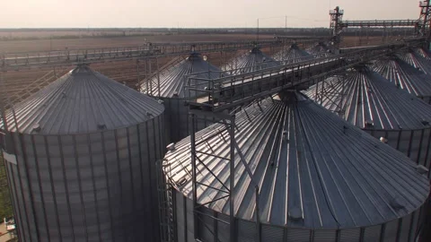 Close-up shot of tanks for processing and storage of soybean and wheat grain Video stock 210403719