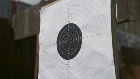 Close up shot of target being riddled with bullets at gun range Stock Footage 299173926