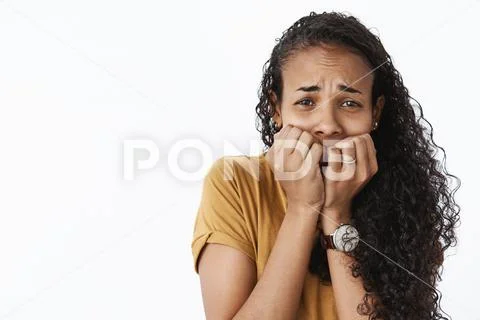 Close-up shot of terrified scared timid african american woman frowning trembing Stock Photos