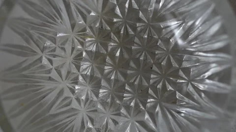 A close-up shot of a textured diamond-patterned clear glass bowl Stock Footage 332580364