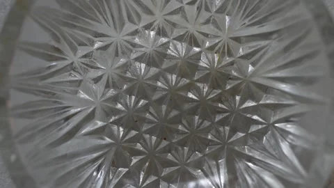 A close-up shot of a textured diamond-patterned clear glass bowl Stock Footage 332580374