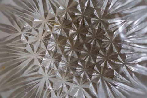 A close-up shot of a textured diamond-patterned clear glass bowl. Stock Photos