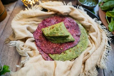 Close up shot of thepla's made with beetroot and fenugreek in a white cloth. Stock Photos