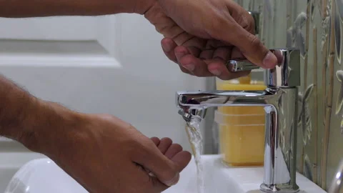 Close shot of thin male hands taking out hand-wash and cleaning the hands Stock Footage 147242849