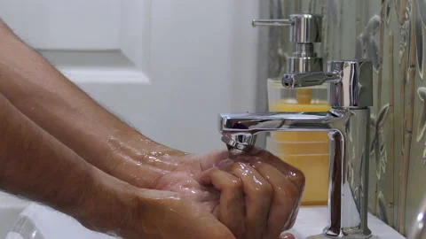 Close shot of thin male hands cleaning the foam and washing hands with water Stock Footage 147243073