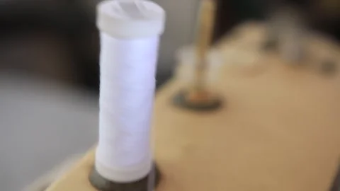 A close up shot from a thread spool on an old sewing machine working in southeas Stock Footage 264528521