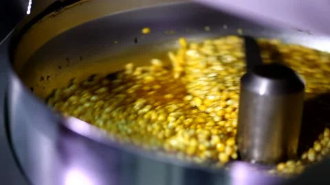 Close up shot of tiny dry corn seeds mixing with cheese caramel sweet flavoured  Stock Footage 137541553