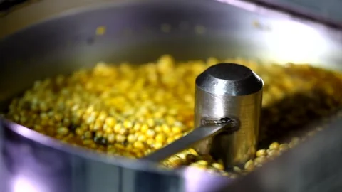 Close up shot of tiny dry corn seeds mixing with cheese sweet caramel flavoured  Stock Footage 137541556