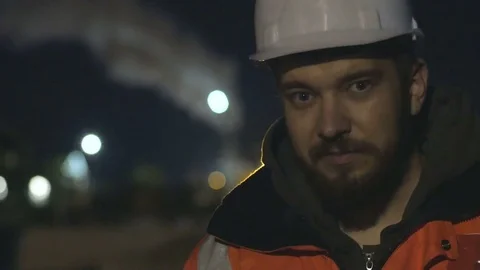 Close up shot of tired worker in the hard helmet during night shift.4k Video stock 83761562