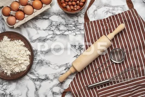 Close-up shot. Top view of a baking ingredients and kitchenware on the marble Stock Photos
