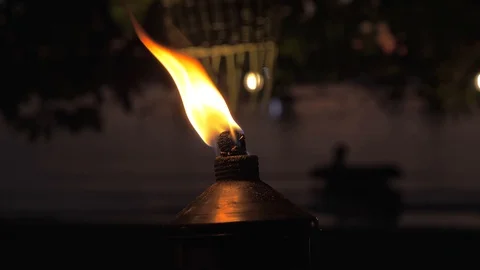 Close-up shot of torch with fire and flames burning on tropical beach on sunset. Stock-Footage 108624864