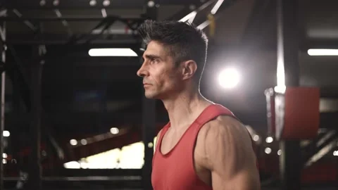Close shot of Tough man pumping his hands with dumbells Stock Footage 201407175