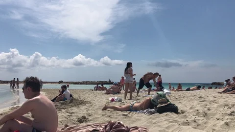 Close Up Shot of Tourists lay down at the sand of a beach Stock Footage 91208686