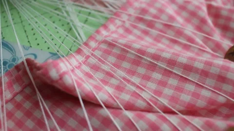 Close up shot of traditional bobbin lace making with wooden bobbins, colorfu Видео 342190645