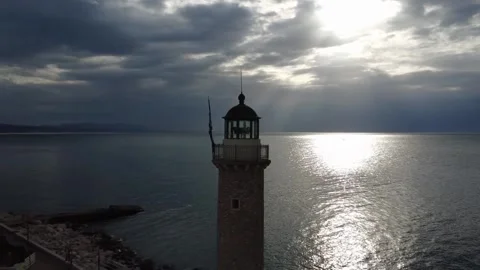 Close up shot of a traditional lighthouse on a pier during a golden sunset Stock Footage 338106624