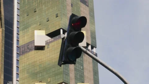 A close up shot of a traffic light as it changes from orange to red, the Stock Footage 164299173