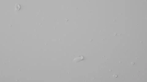 Close up shot of transparent glass on the white background. Reverse shot of Stock Footage 259639552
