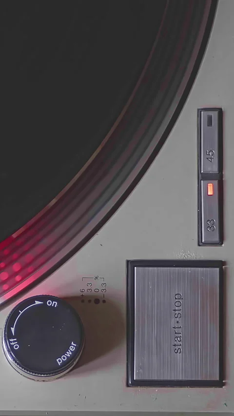 Close-up shot of a turntable being turned on and started. The needle drops on Video stock 303344752