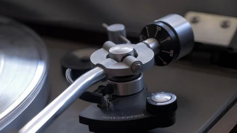 Close up shot of turntable tone arm as needle drops on record Stock Footage 88763928
