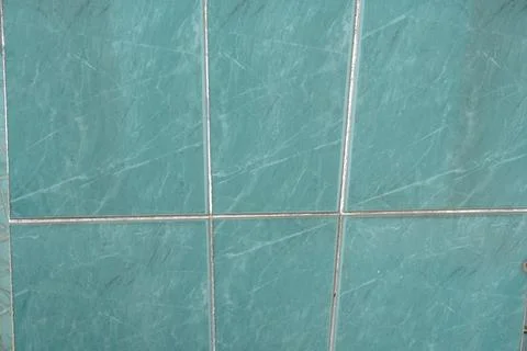 Close-up shot of turquoise marble-patterned tiles with thin silver grout lines 写真素材
