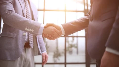 Close up shot of two business people shaking hands in the office Stock Footage 263884751
