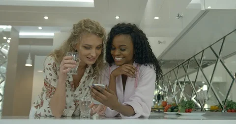 Close-up shot of two cheerful beautiful young multi-ethnic girl friends happily Stock Footage 86421026