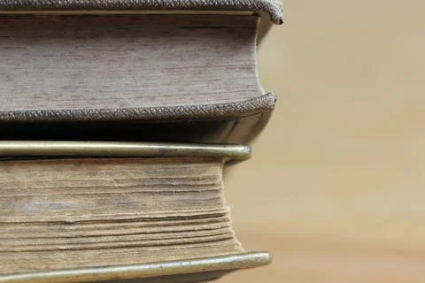 Close-up shot of two closed books on the table with old weathered pages Stock Photos
