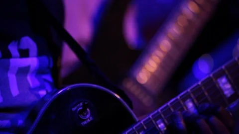 Close up shot of two men playing electric guitar on stage at night Stock Footage 98745526