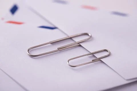 Close up shot of two paperclips on an envelope Stock Photos