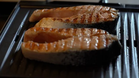Close up shot of two salmon steaks on the grill Stock Footage 114001306