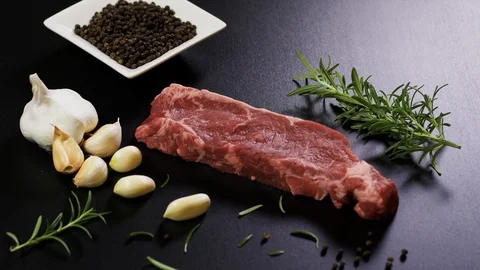 Close up shot of uncooked meat with pepper, rosmarinus and pepper Stockbeeldmateriaal 102609690