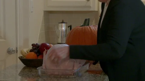 Close shot as uncooked turkey is set on counter, 4K. Stock Footage 81603973