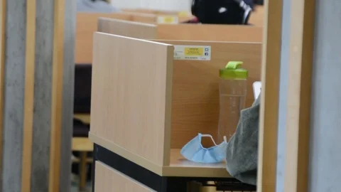 Close shot, university library on campus, face mask on a desk Stock Footage 126298627
