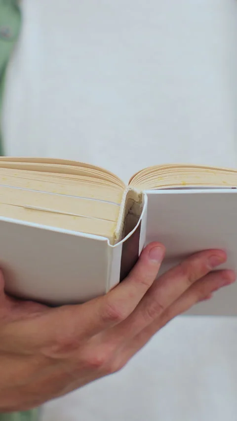 Close up shot of unrecognizable man reading a book in public library Stock Footage 345145307