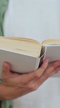 Close up shot of unrecognizable man reading a book in public library, turni.. Stock Photos