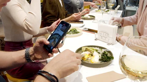 Close-up shot of unrecognizable man videotaping his food using smartphone at a Stock Footage 150969530