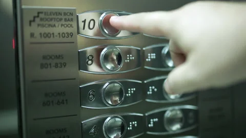 Close-up shot of unrecognized person pressing the button in passenger elevator Stock Footage 231590957
