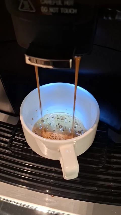 Close-up shot from an upper angle showing an automatic coffee machine brewi.. Stock Footage 339428724