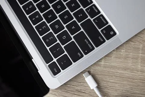 Close up shot of usb c cable plugging to a laptop computer. Stock Photos