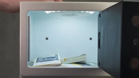 Close shot of user putting phone with important data into safe to hide it from Stock Footage 323538752