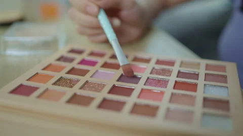 Close-up shot of using a powder to brush the eye shadows to create a beautifu Stock Footage 239553239