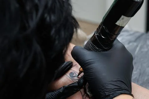 Close up shot using tattoo machine in tattoo studio Stock Photos