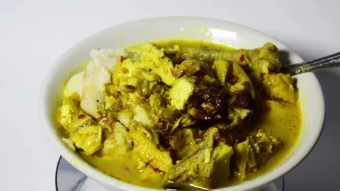 A close-up shot of vegetable rice cake with tofu and Indonesian meat Stock Footage 273164139
