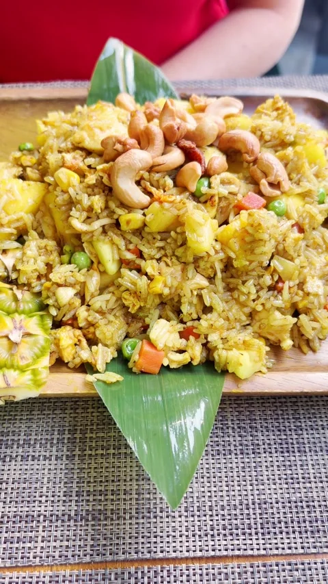 Close-up shot of vibrant Thai pineapple fried rice, mixed with green peas Stock Footage 340419708