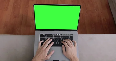 Close up shot, view from above. Hands of man typing code or message on green POV Stock Footage 138293131