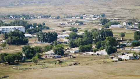 Close-up shot of view down into sunny valley from hilltop of remote village Stock Footage 122598266
